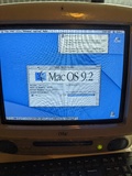 Blue iMac G3, running MacOS 9.2.2 with a cheap Logitech USB keyboard slightly visible