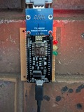 An ESP8266, on top of a protoboard, zip-tied to a MAX3232 RS232 convertor